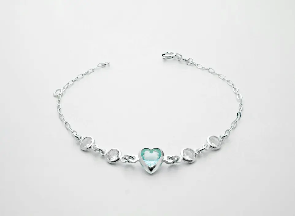 a silver bracelet with a heart on it